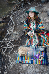 A medicine woman offers tobacco in ceremony