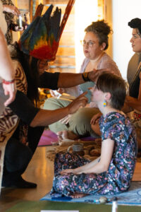 A child receives a plant medicine blessing from Sapara Shaman, Manari Ushigua