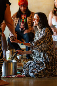 A medicine woman serves cacao at a plant medicine ceremony