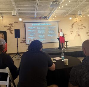 A presenter speaks about mindset on stage at a business coaching conference in Lexington, Kentucky